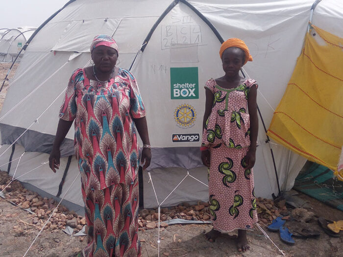 Women in front of tent.