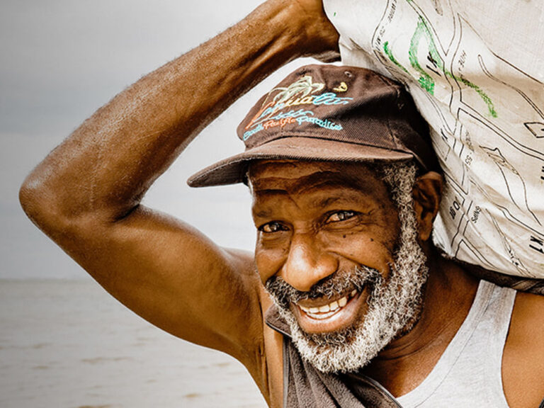 Man in Vanuatu receiving ShelterBox shelter kit following cyclone Harold