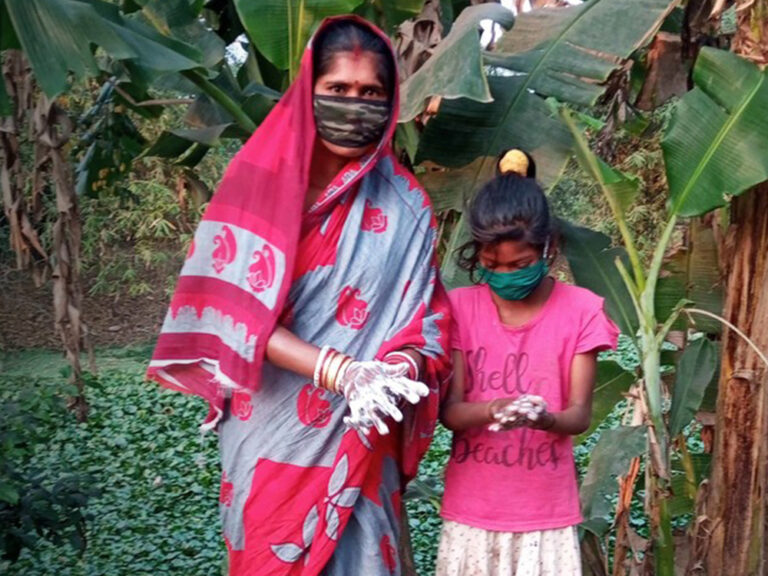 A woman and a child washing their hands