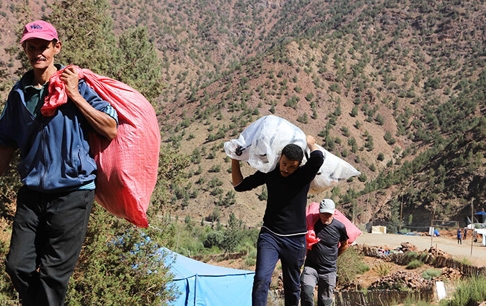 People carrying bags of aid in Morocco