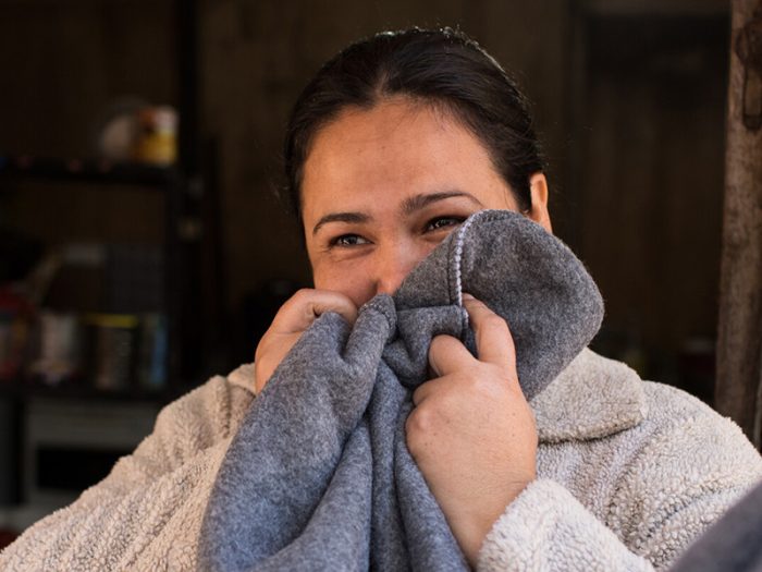 Woman holding blanket to her face in Paraguay